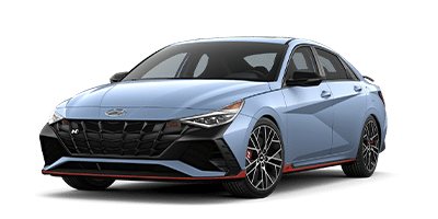 Sleek blue Hyundai sedan with sporty design, black grille, and alloy wheels.