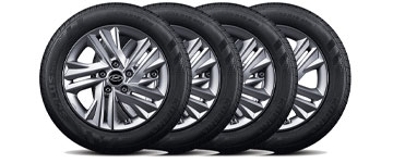 Four stacked car tires with alloy rims, showcasing a sleek design. Ideal for automotive enthusiasts.