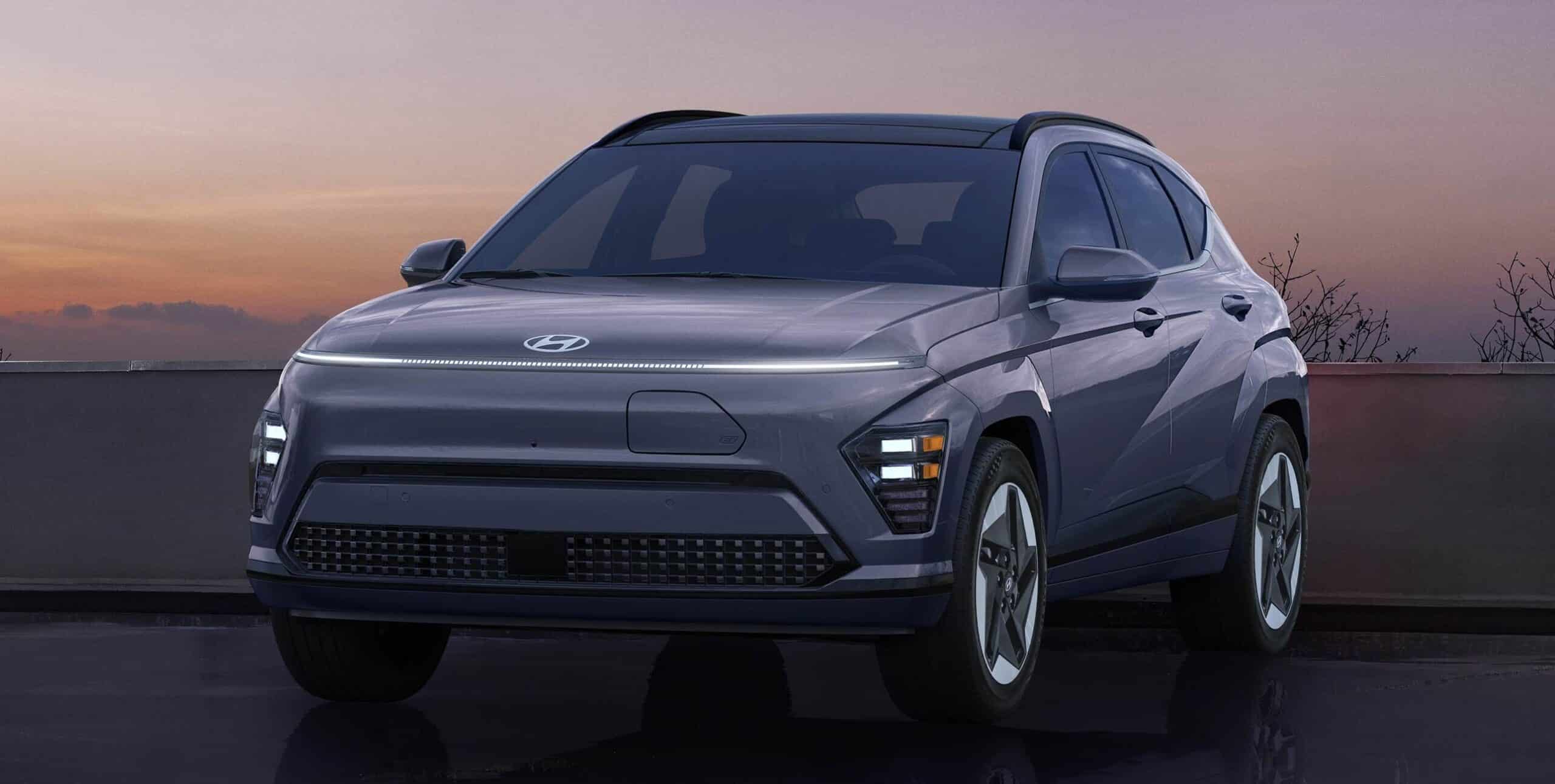 A sleek, modern SUV parked against a sunset backdrop, featuring distinctive headlights and a bold design.